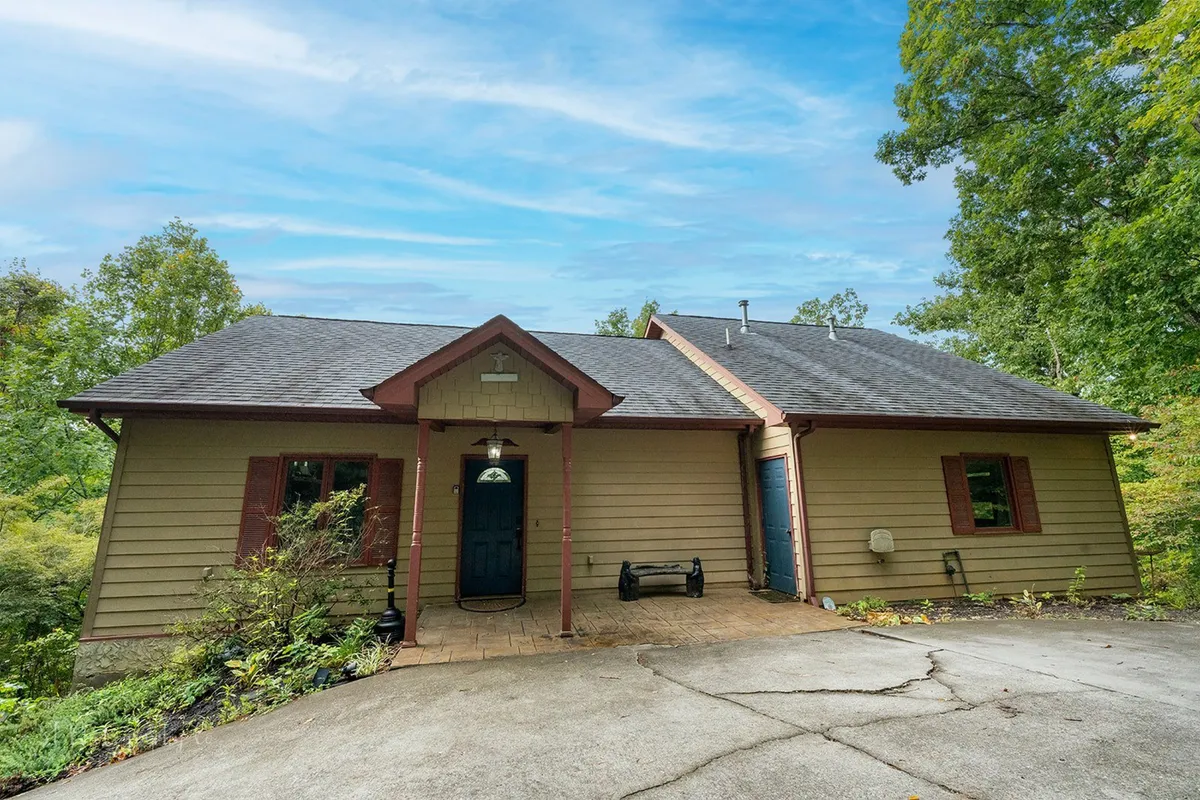 This exterior shot highlights the welcoming front door, driveway, and tasteful landscaping of Enchanted Primrose. The inviting entryway hints at both the comfort inside and the easy access to the great outdoors and nearby national park trails.